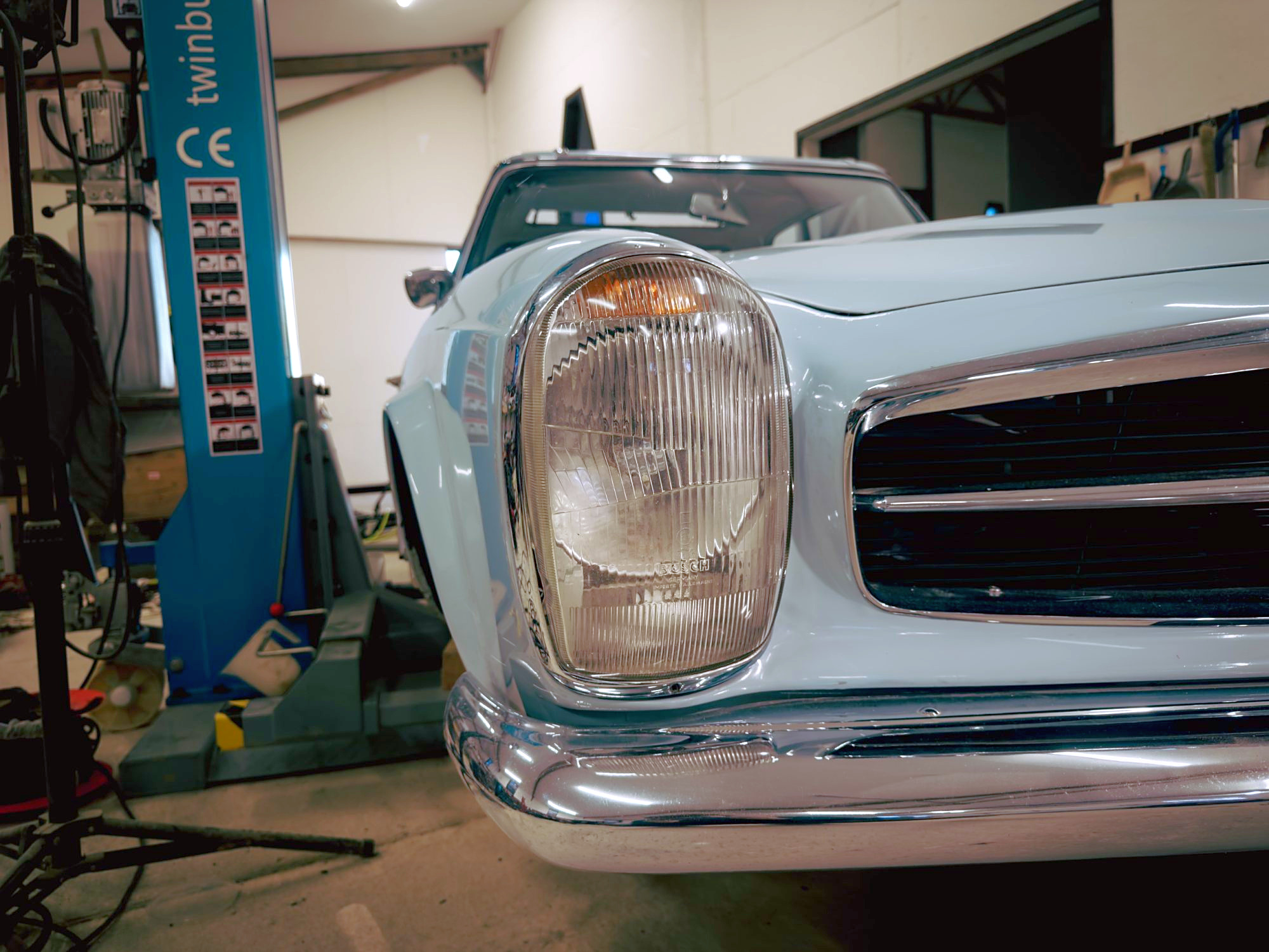Close-up of the Pagoda’s Bosch headlamp and chrome bumper